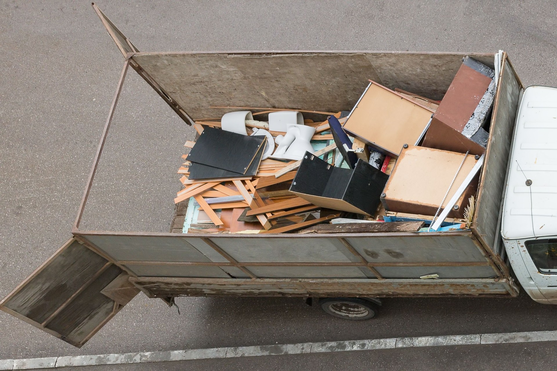 Truck with an open body on the loading of solid waste, top view.